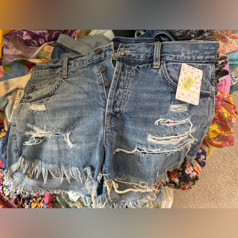 Free People Blue Distressed Jean shorts with floral underlay